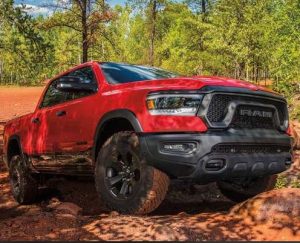 A red RAM 1500 driving on a dirt road near Anderson, Indiana