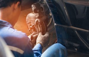 A mechanic performing a brake repair near Anderson, Indiana.