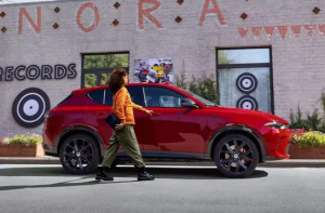 A photo of a 2024 Dodge Hornet parked in front of a record store near Anderson, Indiana