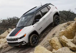 A 2024 Jeep Compass driving down a steep slope while driving offroad near Anderson, Indiana