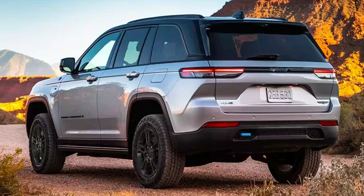A rear photo of a silver 2024 Jeep Grand Cherokee 4xe parked outdoors near Anderson, Indiana