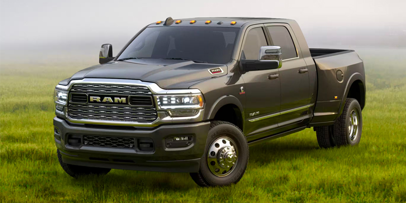 2026 RAM 3500 heavy-duty pickup with dual rear wheels on a grassy field.