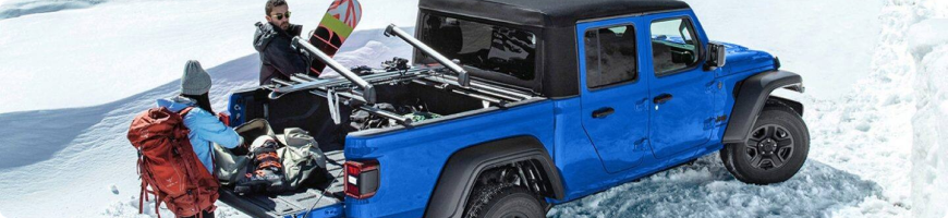 2026 Jeep Gladiator towing a trailer, rated from 4,500 to 7,700 lbs by trim