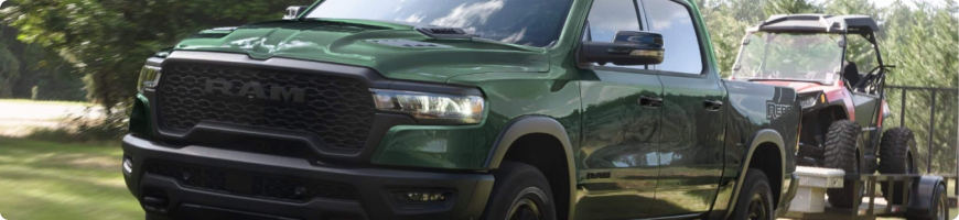 2026 RAM 1500 towing a trailer, rated up to 11,610 lbs